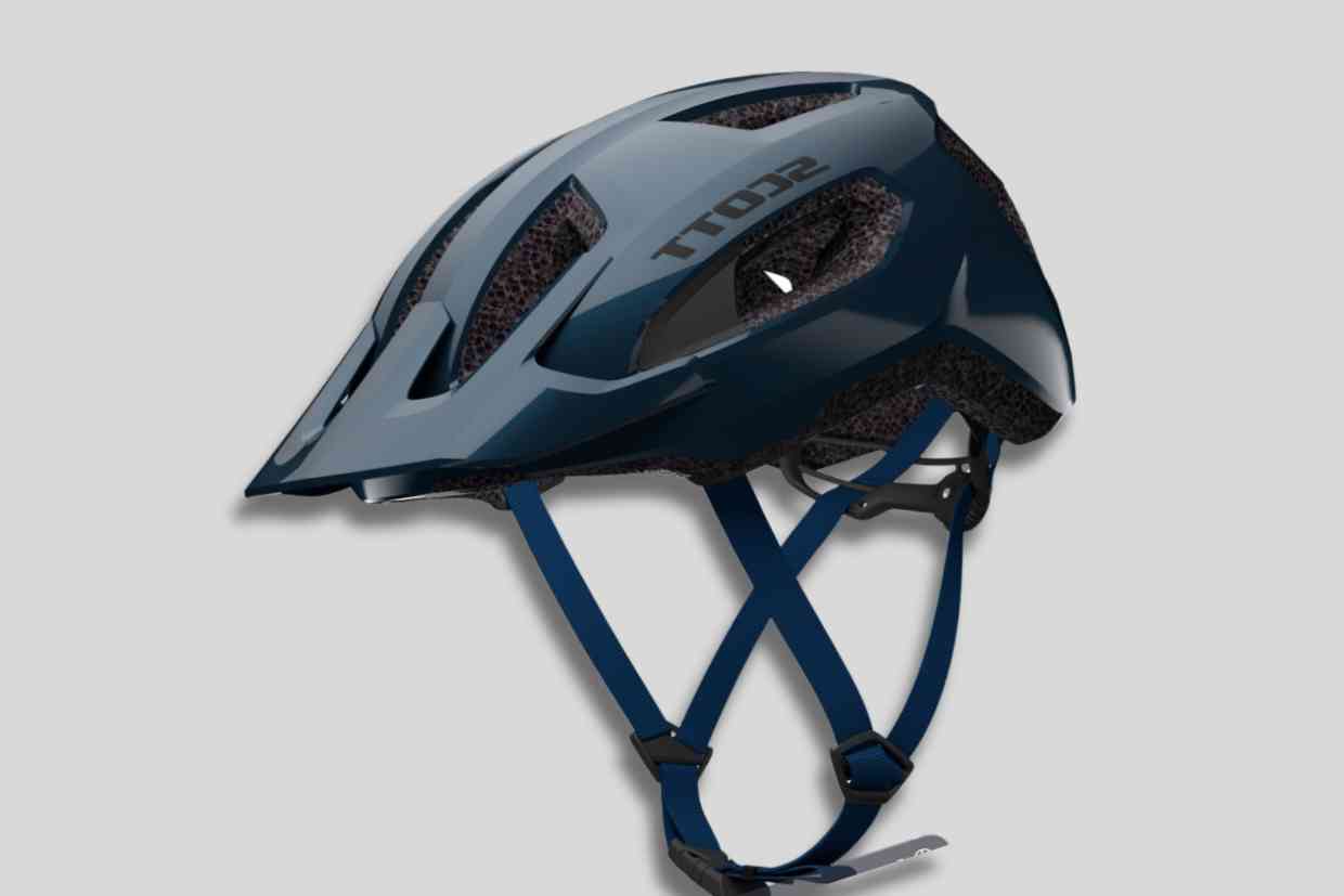 Capacetes_300-Corpo-4 Capacete azul-escuro da marca Scott com tiras ajustáveis, projetado para ciclistas de mountain bike.