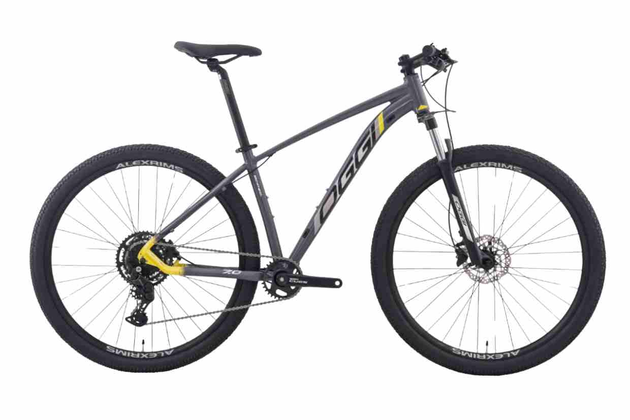 Bicicletas mountain bike Oggi Big Wheel 7.0 azul com detalhes verdes e suspensão de alto curso.
